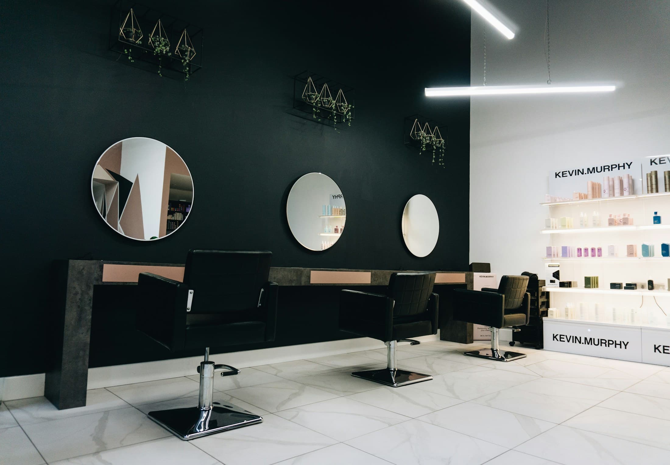 Salon stations with mirrors and product shelving